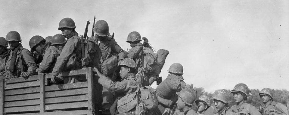 Japanese-American troops climb into a truck as they prepare to move their bivouac area. 2nd Battalion, 442nd Combat Team, Chambois Sector. France. 10/14/44. Courtesy of the Seattle Nisei Veterans Committee and the U.S. Army