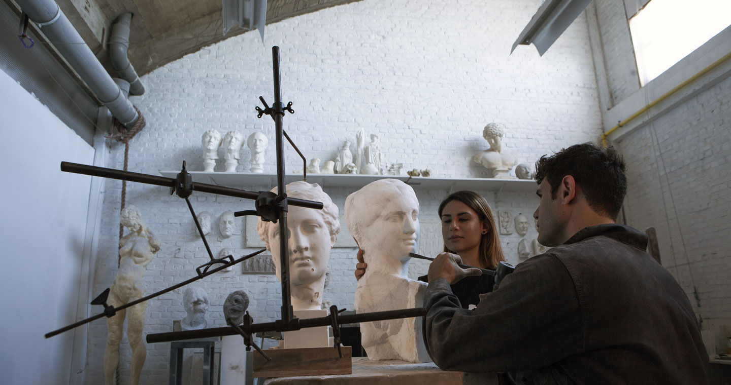 Sculptor carving a life size marble bust