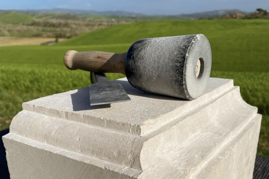 Hammer and chisel on a limestone carved with an ovolo and cavetto