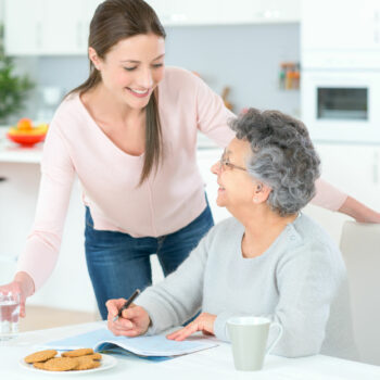 Carer helping woman at home