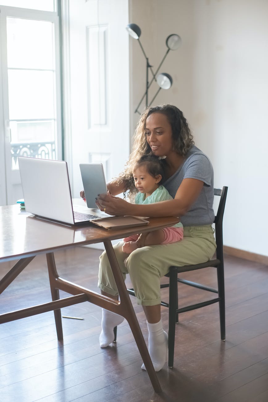 a mother taking care of her daughter while working