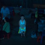 Ho- Chi- Minh city, city district, at night, kid looking up, aim-frame photography