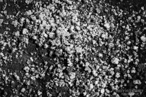Black and white close-up of the salt grains and the earth in the salt fields of Gokarna, South-India 2010