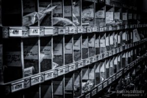 Black and white photo of an old filing compartment in a closed cotton UCO factory in Brugge, Belgium.