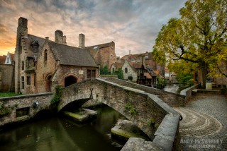 The smallest bridge in Brugge, Belgium with surrounding houses and parc