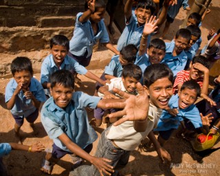 Portrait of happy waving Indian school boys on the streets of South-India