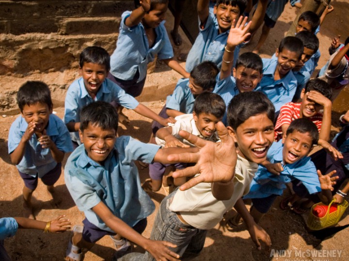 Portrait of happy waving Indian school boys on the streets of South-India