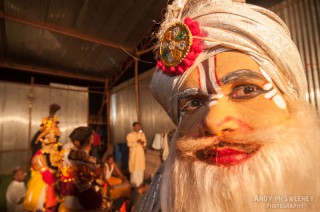 Colorful close-up portrait of an Indian performer with turban and make-up during a ceremony in South-India
