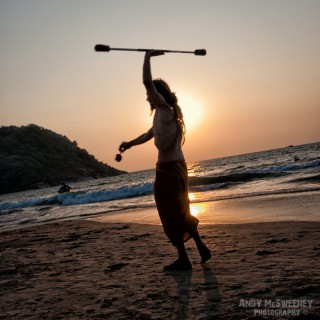 Hippy traveller performing on the beach by sunset in South-India
