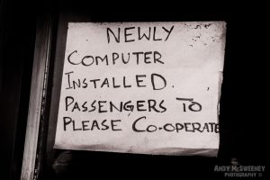 Black and white paper sign at internet café saying "Newly Installed Computer" in India