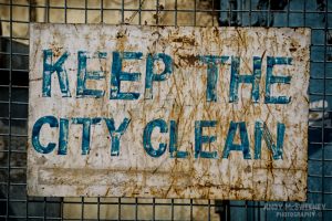 Old colorful street sign in India saying "Keep The City Clean"