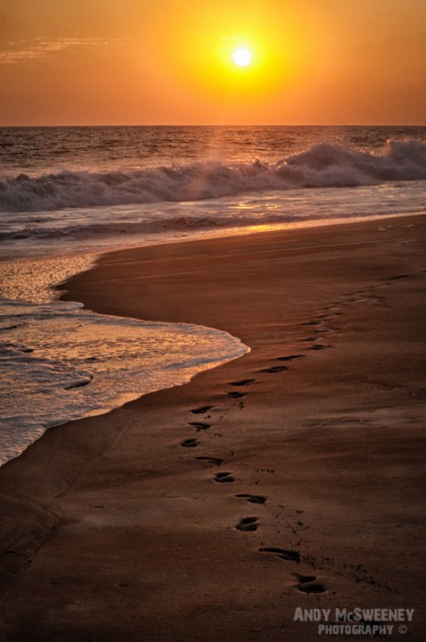 Footsteps in the sand at sunset in India