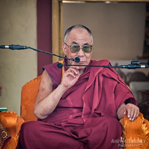 His Holiness the Dalai Lama taping his microphone at a public speech in the monastery of Bylakuppe, South-India