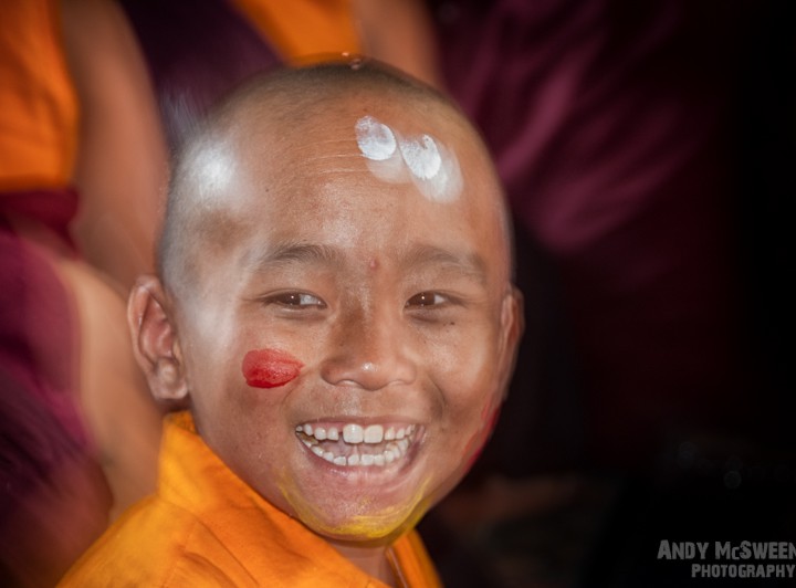 Colorful portrait of a little monk during puja ceremony in the monastery of Bylakuppe, South-India