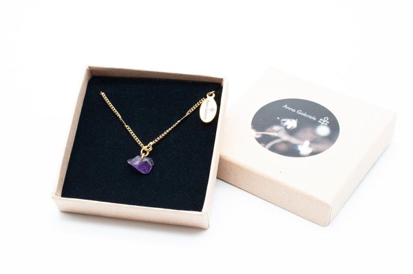 Image of a necklace with an amethyst pendant in a box