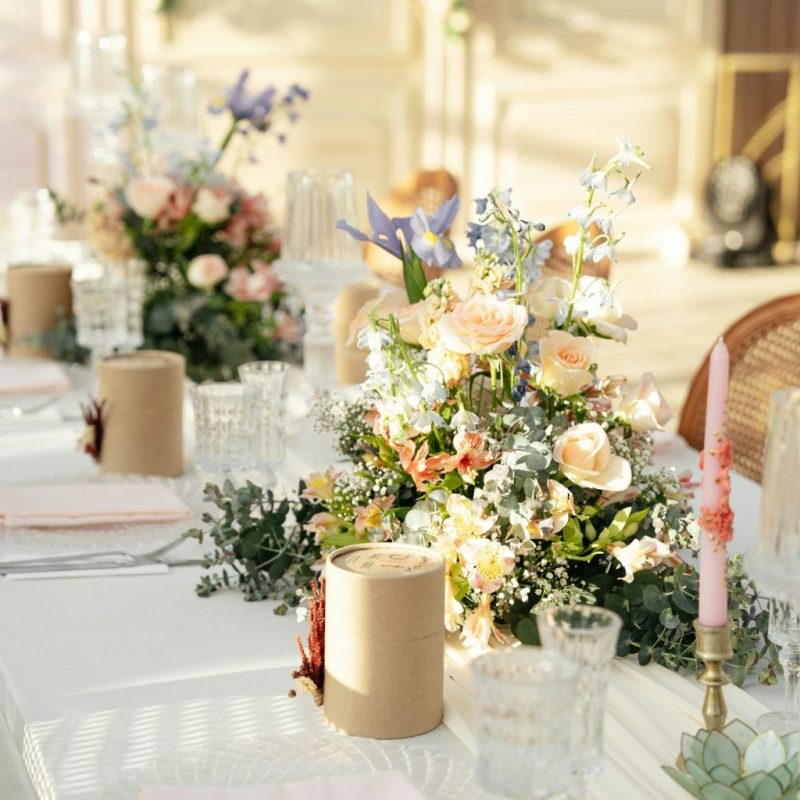 Elegant bordopdækning med service, blomster og lys til fest og bryllup
