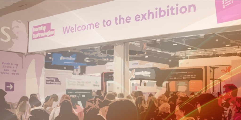 Aristo-branded presence at a crowded exhibition hall featuring a pink banner and signage, illustrating a learning technology event with many attendees.