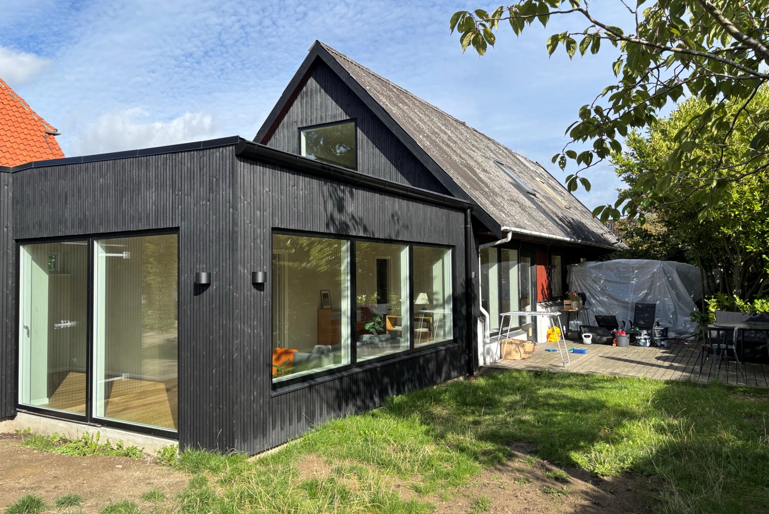 Tilbygning med sort træbeklædning, stue og soveværelse - Arkinaut Arkitekter aps 3