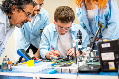 Group of young people in technical vocational training with teacher