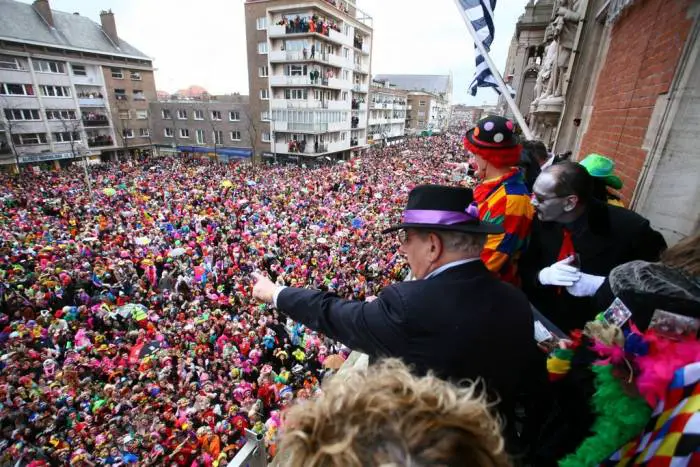 At the carnival in Dunkirk people from the town hall throw fish to the crowd