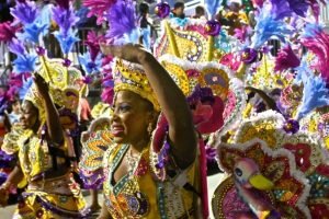 Junkanoo carnival groups wear ostentatious costumes full of color and feathers