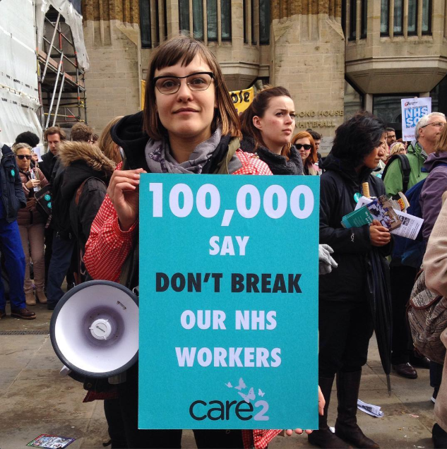Photo of Beth with a megaphone and a sign reading "100,000 say don't break our NHS workers"