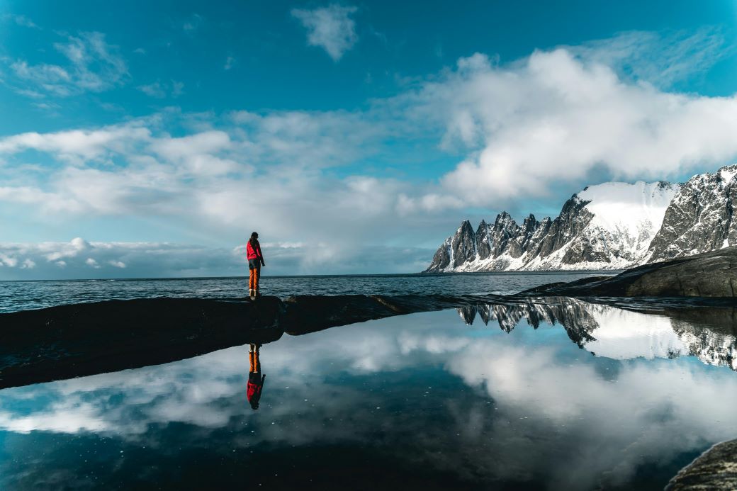 Global: an explorer in a northern landscape, with views of the mountains and sea