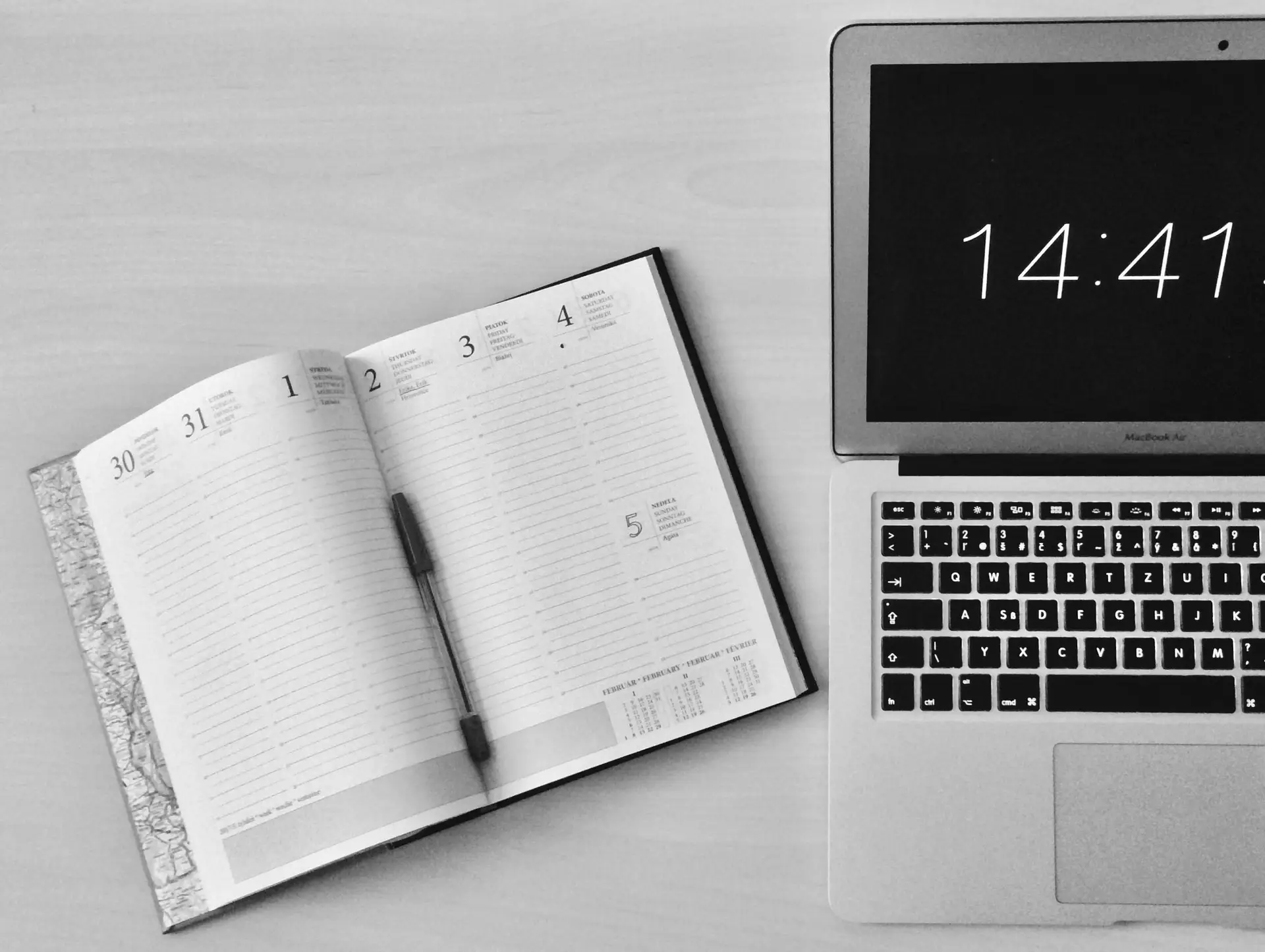 A MacBook and a notebook