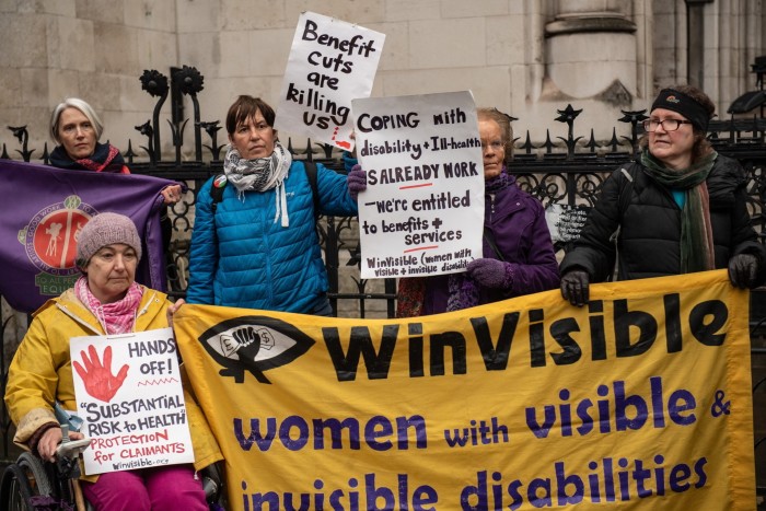 Disability campaigners protest outside the High Court as they challenge a proposed change to benefits