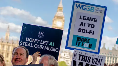PA Media Creatives in the music industry protest outside UK Parliament. A dark blue placard from trade association UK Music reads: "Don't let AI steal our music". Another beside it, from The Writer's Union, says: "Leave AI to sci-fi".