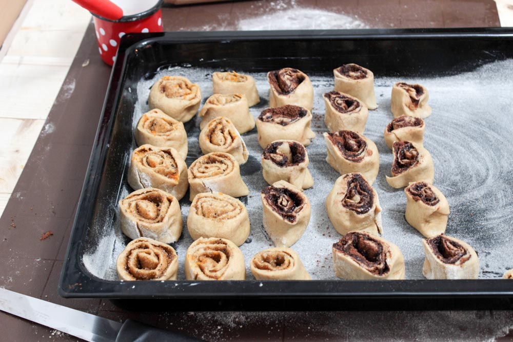 Cardamom and cocoa rolls on a baking pan