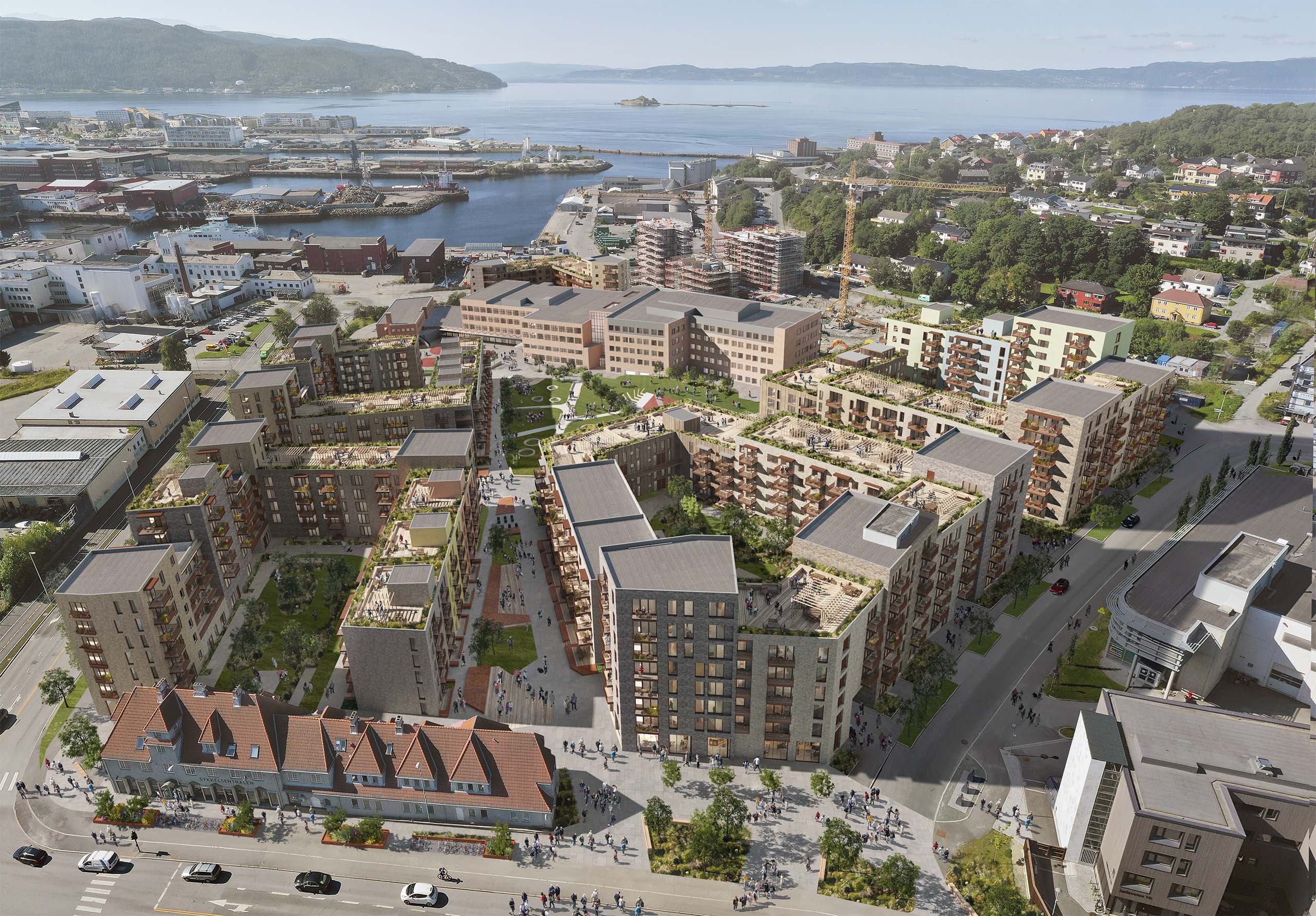 <strong>Jarlheim Nyhavna</strong> Aerial view of the residential masterplan in Trondheim Norway designed by Pir II developed by Dora Eiendom AS and OBOS Nye Hjem AS showcasing modern apartment buildings green courtyards and urban infrastructure near the waterfront