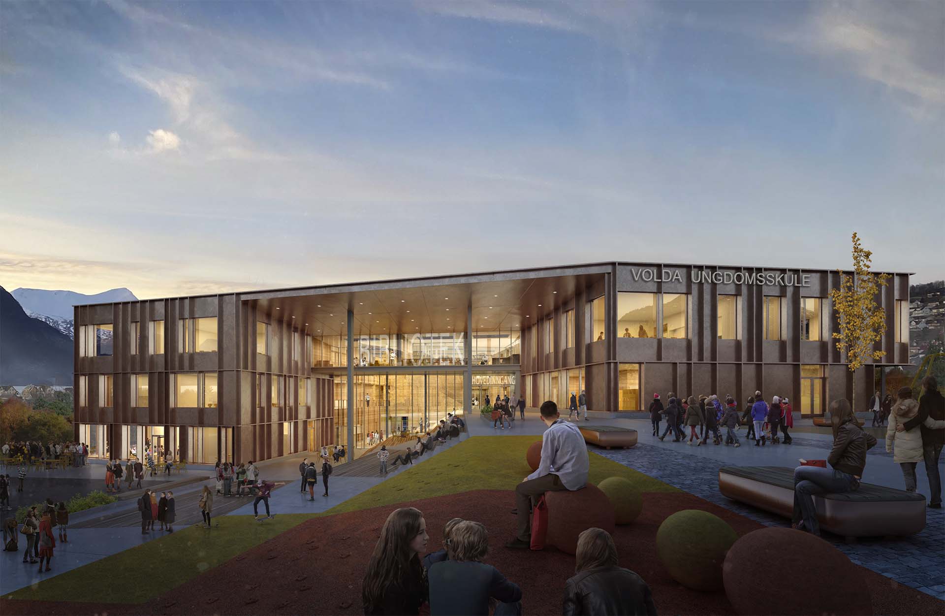 <strong>Volda VGS</strong> – Competition Exterior view of Volda Upper Secondary School in Norway, designed by L2 Arkitekter, showcasing a modern, wooden façade with large glass windows and students gathering in an open plaza during dusk.