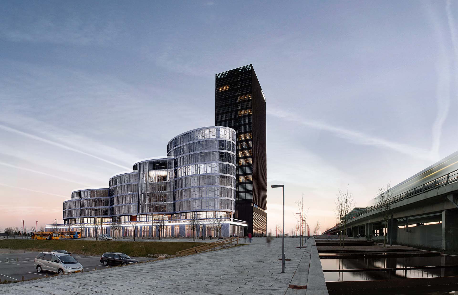 <strong>Kay Fiskers Plads</strong> Kay Fiskers Plads in Copenhagen Denmark by Danielsen Architecture features modern glass facades and curved office buildings at dusk