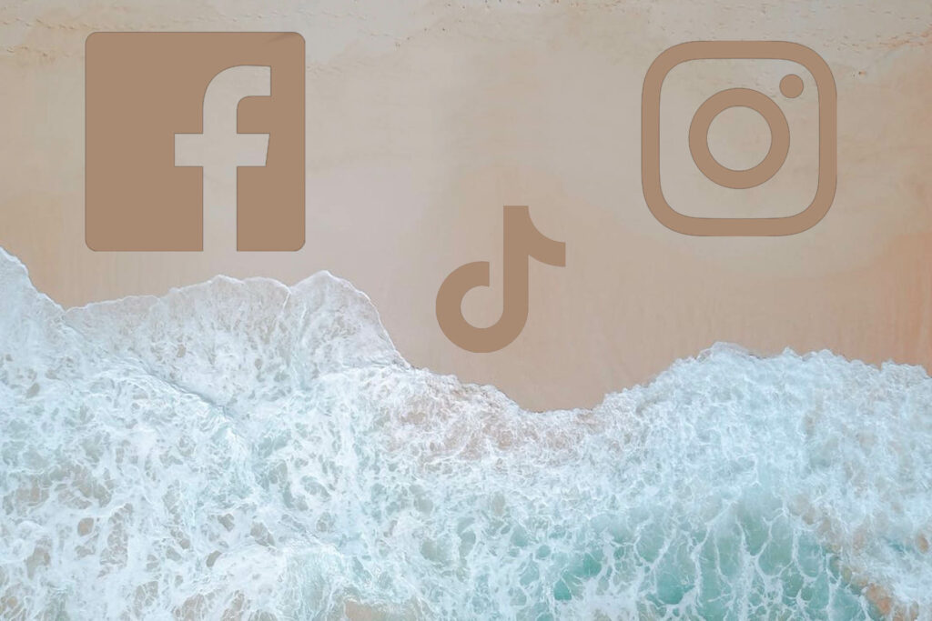 loghi di facebook tiktok e instagram sulla spiaggia con mare