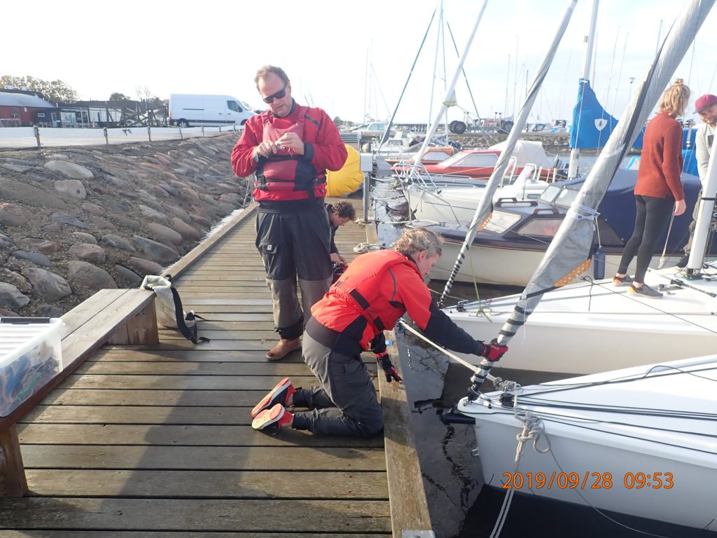  En rigtig rorsmand (Jan Schlüter) checker neglene mens Sarah gør båden klar.