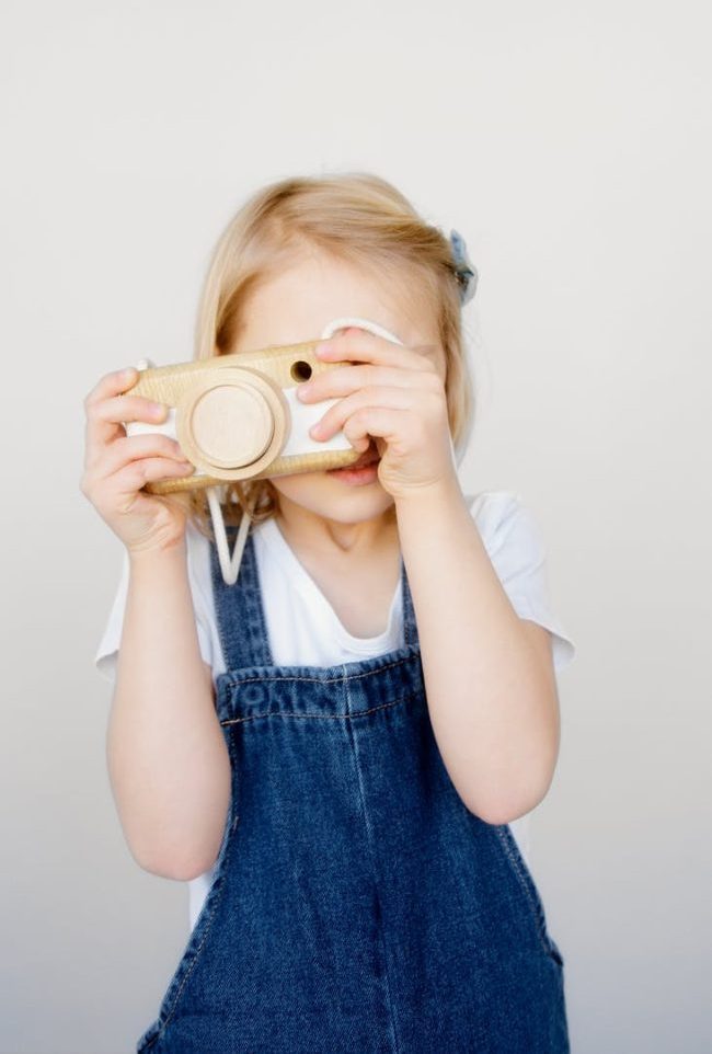 girl taking photo using a camera