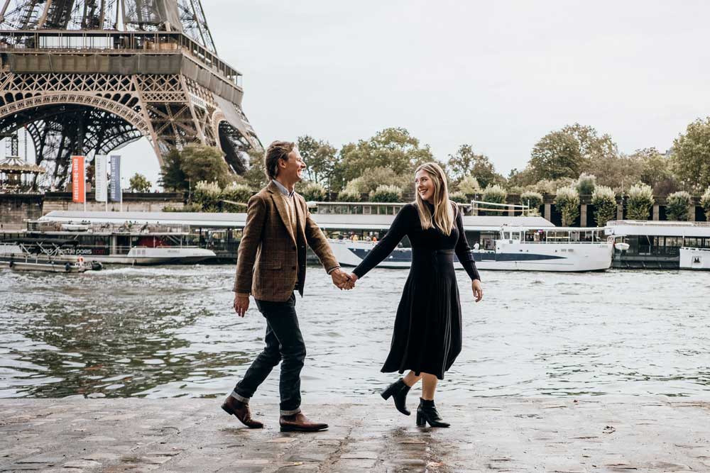 Married man and woman traveling as a couple walking along the River Seine in Paris