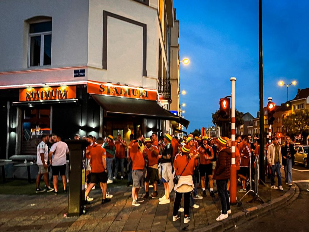 Welsh soccer fans congregate outside of a pub on a groundhopping evening