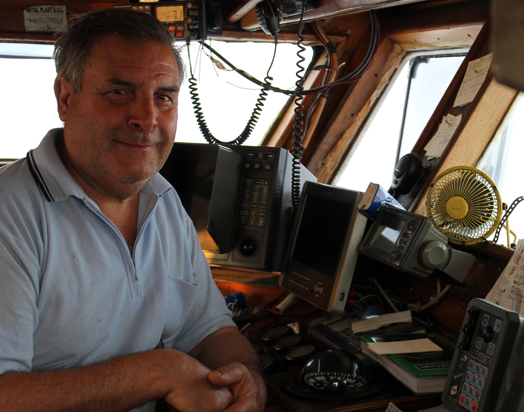 Alfonso in the wheel-house of the boat