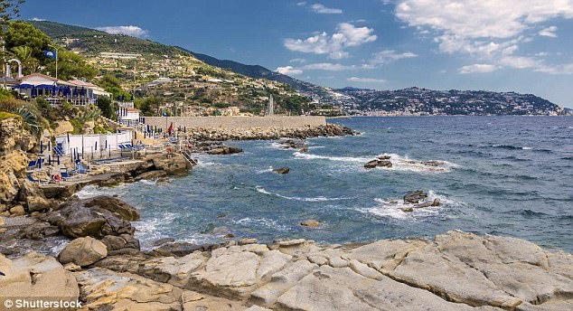 Rocky retreat: Bordighera edges the blue waters where the Alps plunge into the Mediterranean Read more: http://www.dailymail.co.uk/travel/travelsupplement/article-4392914/Exploring-Italian-seaside-town-Bordighera.html#ixzz4ghfPntxF Follow us: @MailOnline on Twitter | DailyMail on Facebook