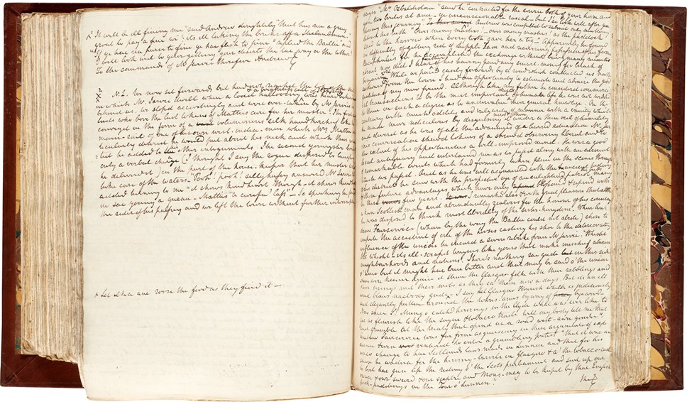 Photo of the handwritten manuscript of Rob Roy lying open on a table