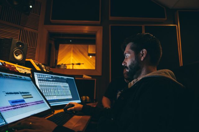 audio engineer mixing at computer