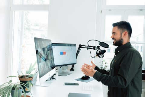 person recording a podcast at a computer on an online video call