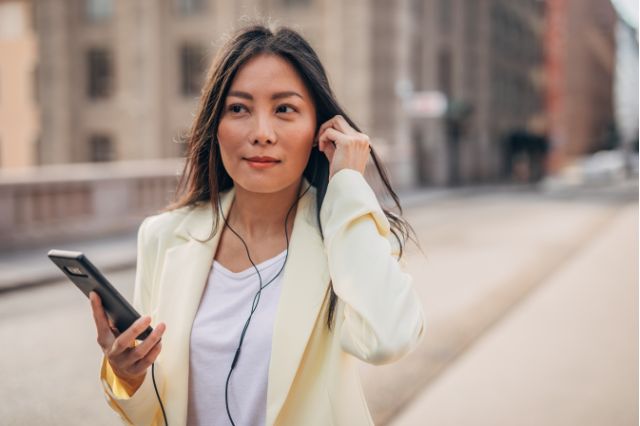 woman listening to podcast with mobile phone