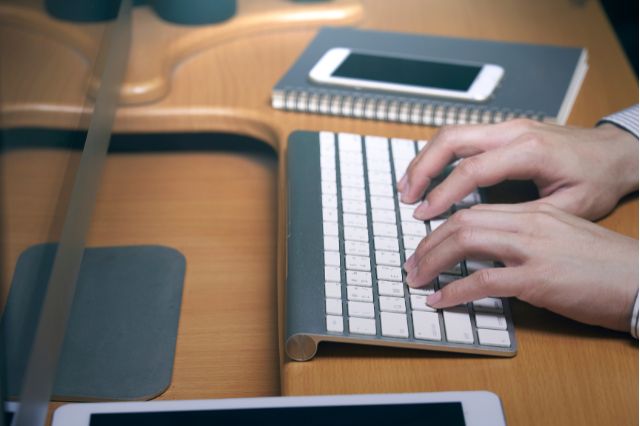 person typing on computer keyboard