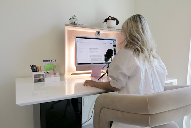 woman sitting at a desk with a computer