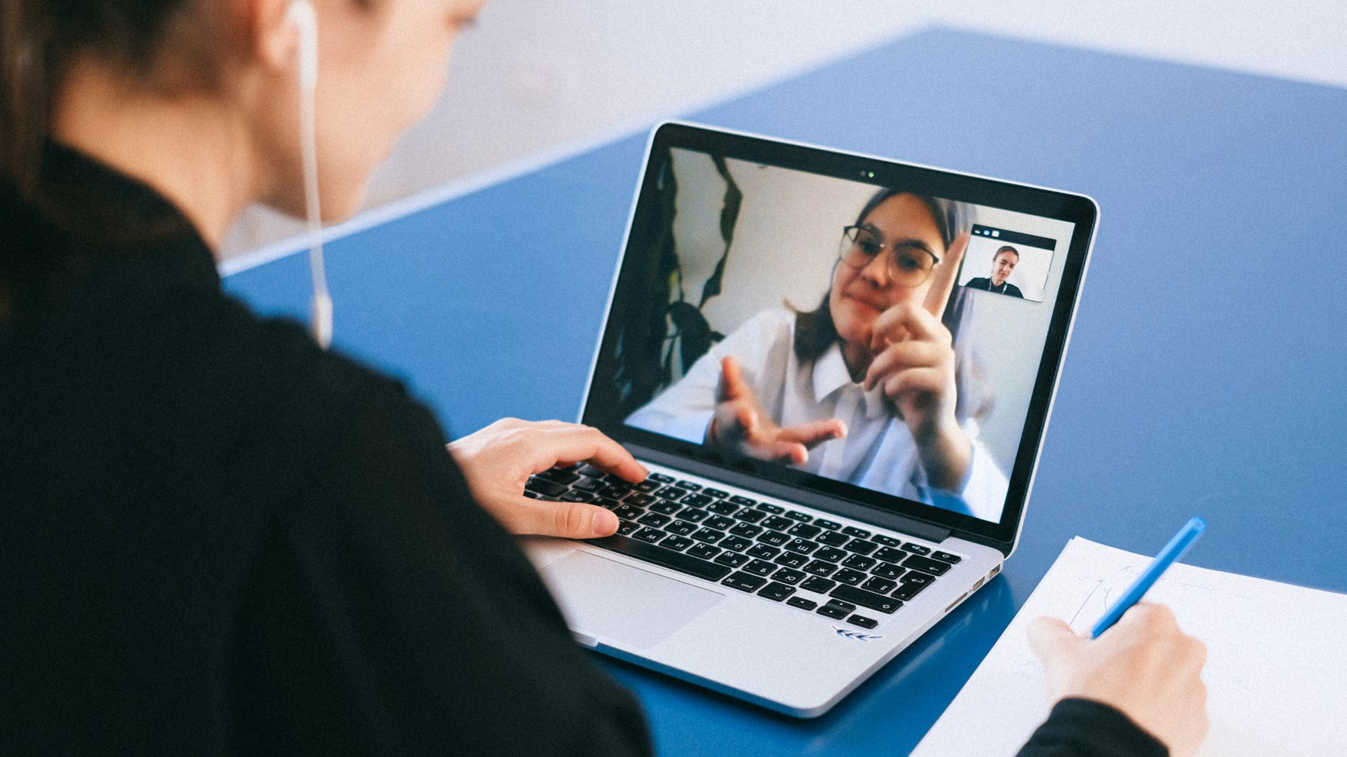 woman sitting at laptop recording remote interview