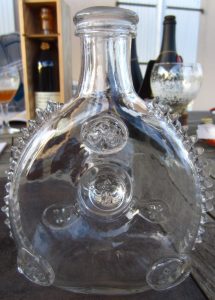 Glass bottle. Looks like 15 and 14 fins respectively. Orientation of the fleurs de lys not all upright; on the bottom is casted in the glass the word 'dispose' (barely visible); click to see details (approx. 1870-1900)