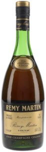 Text in all four corners; above right 70% Proof. Right below: Not less than 24 fl.oz (1970s)